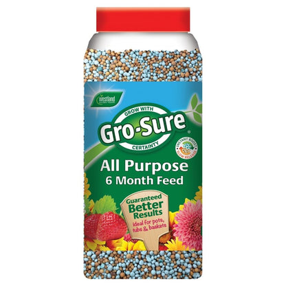 A container of Gro-Sure All Purpose Plant Food 1.1kg delivers slow release nutrients, with a label featuring strawberries, flowers, and the phrase Guaranteed Better Results.