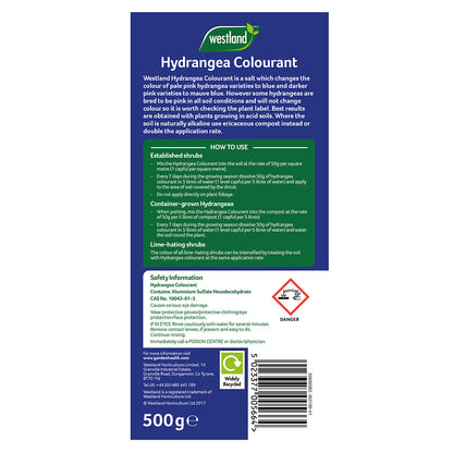 Label for Westland Hydrangea Colourant 500g, explaining the process to turn pink hydrangea flowers blue by acidifying the soil. Features directions for use, safety precautions, and a product weight reference of 500g. Includes advisory and recycling details presented in blue packaging.